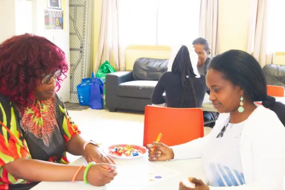 Staff and youth working together at a community activity table